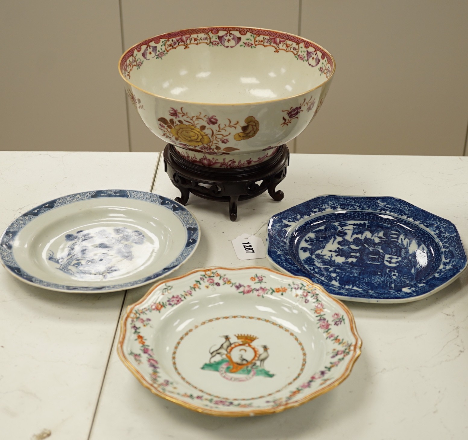 A Chinese export armorial soup plate, for the Spanish market, Qianlong period, with a Spanish coat of arms, possibly Aguado de Las Marismas, an 18th century Chinese export punch bowl on stand, a Chinese blue and white pl